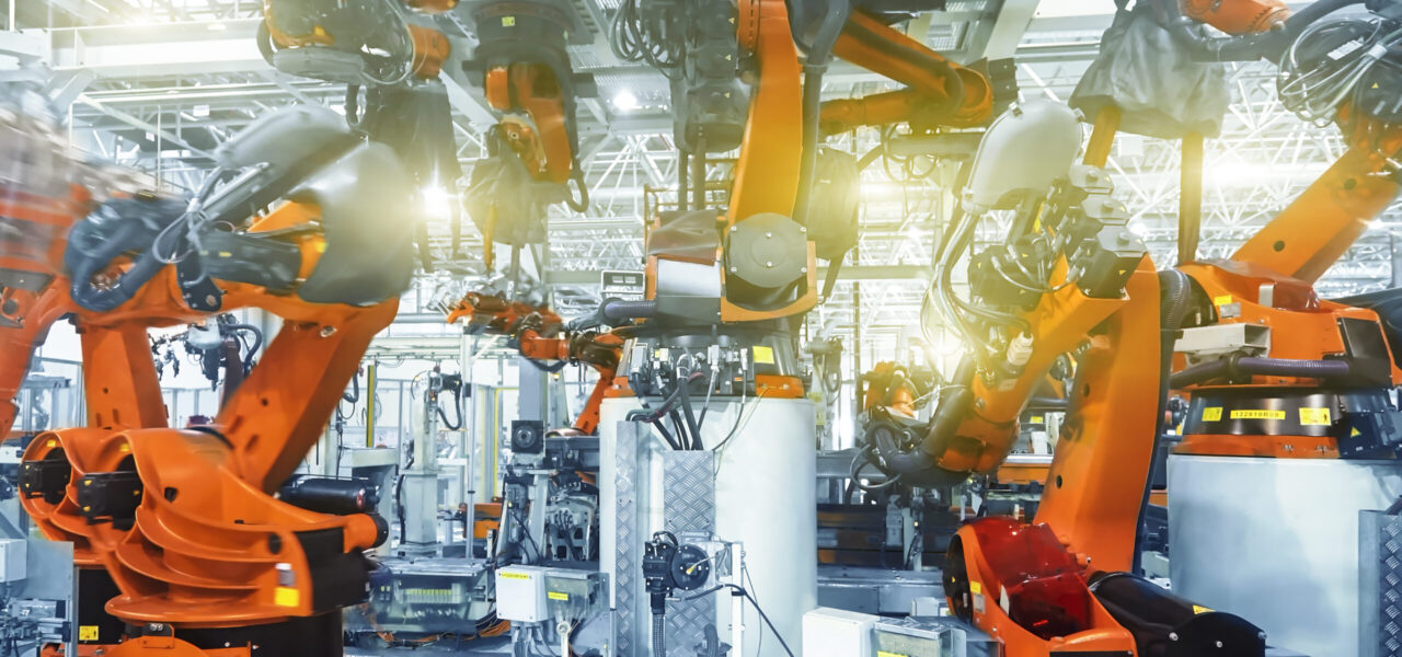 The automated robotic arm in the car manufacturing plant is busy