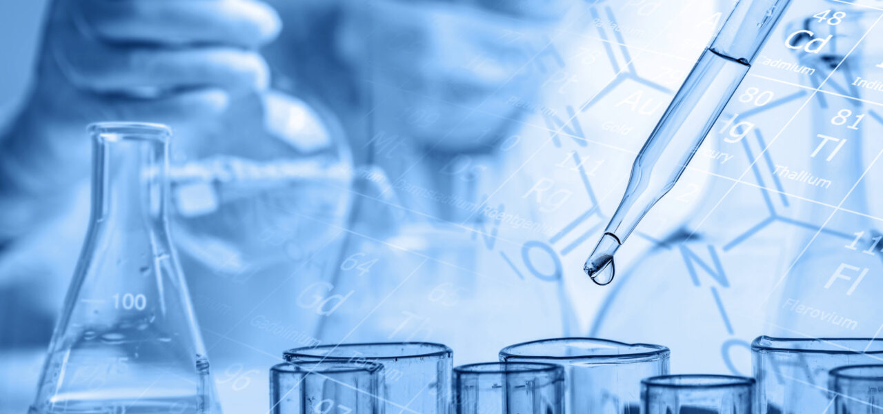 hand of scientist holding flask with lab glassware and test tube