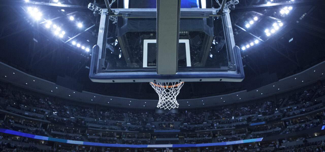 Brightly,Lit,Basketball,Backboard,In,A,Large,Sports,Arena.